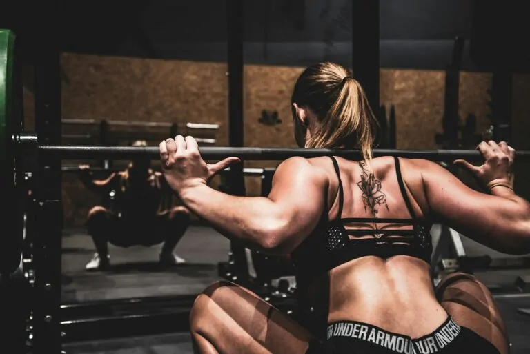 Powerlifter knee sleeves squatting heavy barbell gym
